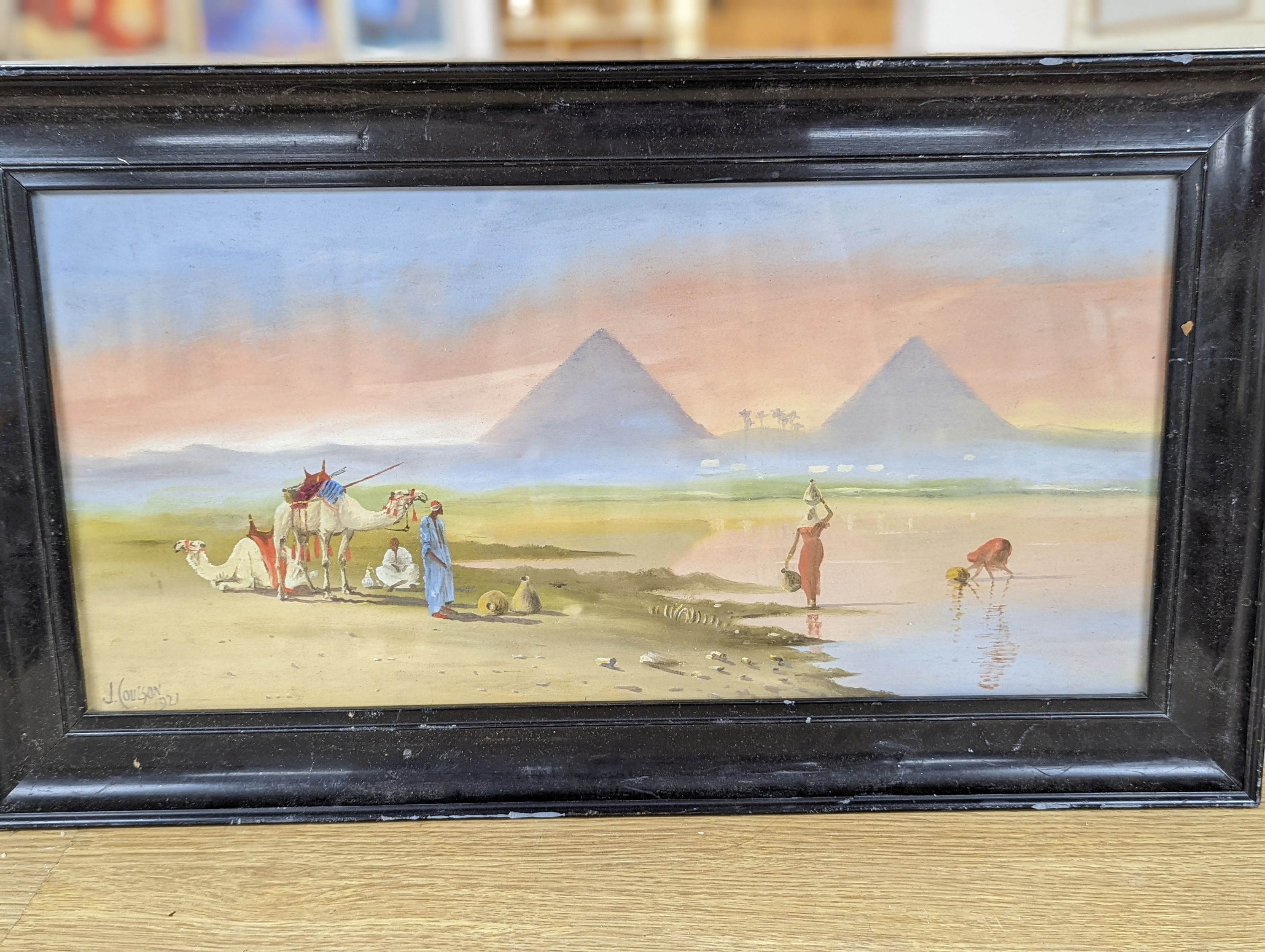 J. Coulson, oil on card, View along the Nile, signed and dated, 1921, 24 x 49cm, a watercolour of fishing boats along the shore and a watercolour of lake scene